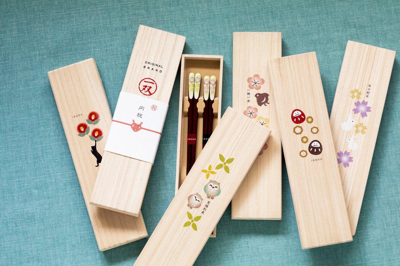 Paulownia wood gift boxes with festive labels, each holding a pair of fine Japanese chopsticks