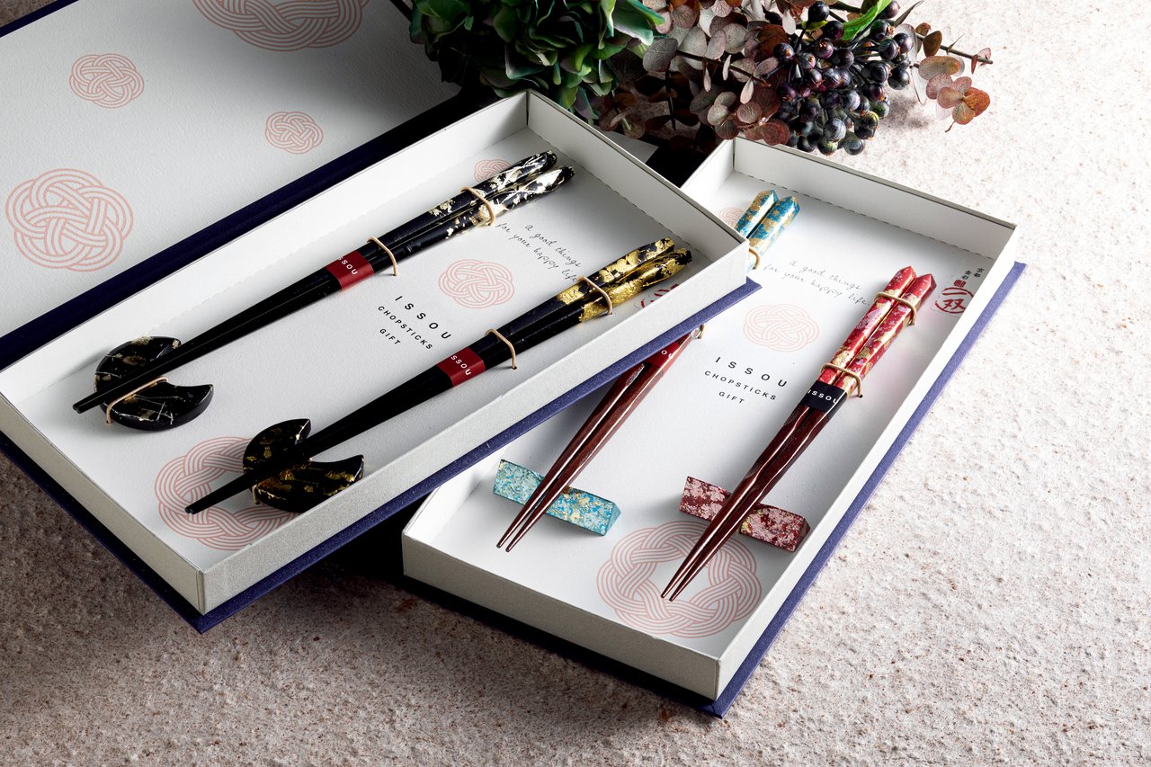 A boxed meoto-bashi couple chopstick set with chopstick rests in a white gift box