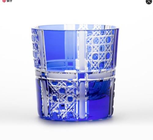 An Edo Kiriko guinomi cut in the kagome basket-weave pattern, the cobalt blue ground showing the six-pointed star geometry at each intersection