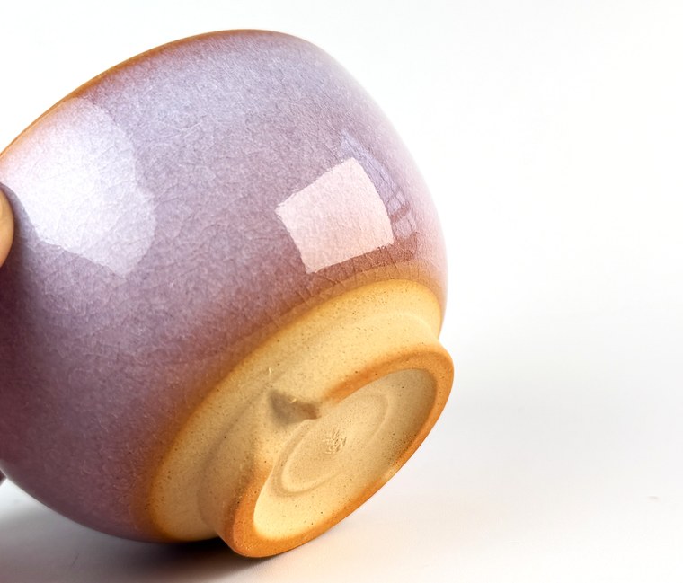 A close view of the foot ring of a purple-glazed Hagi-ware cup