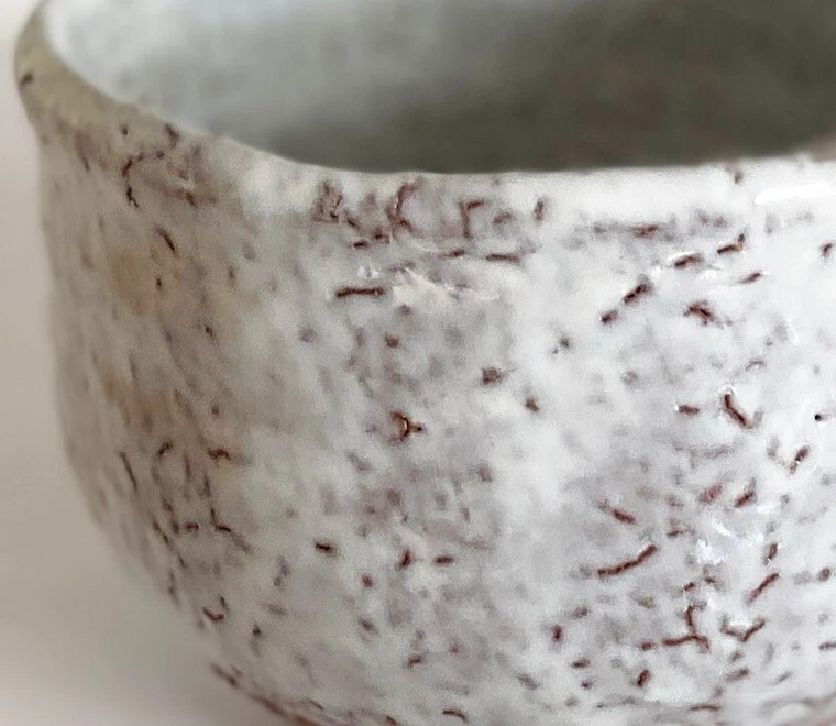 A close view of kairagi texture on a Hagi-ware bowl, a finely pebbled, granular surface in the glaze
