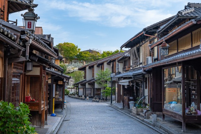 A traditional stone-paved street of old wooden machiya townhouses in Kyoto